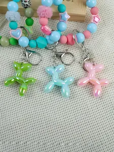 Close-up of cute pearlescent balloon dog charms on colorful silicone beaded wristbands