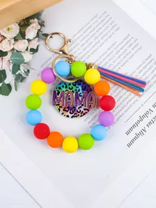 Macro view of colorful silicone bead bracelet keychain featuring a MAMA charm and tassel