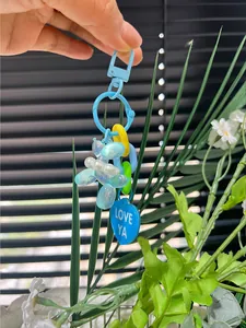 Detail of balloon dog keychain with colorful chain links and LOVE YA heart tag