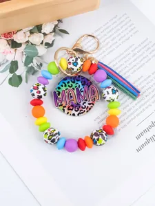 Close-up of a colorful silicone beaded wristlet keychain with MAMA leopard charm.