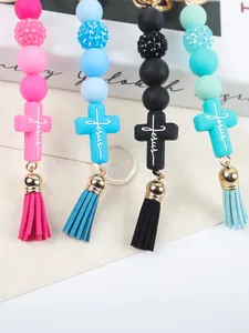 Detail of silicone beaded keychains with Jesus cross charms and colorful tassels