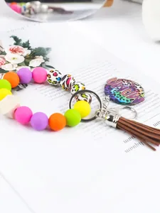 Close-up of colorful silicone bead keychain with leopard print MAMA charm and tassel