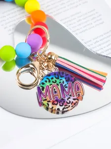 Close-up of MAMA leopard print acrylic pendant on colorful silicone bead keychain