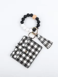 Detail view of checkered card holder attached to a silicone bead wristlet keychain