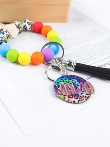 Detailed view of rainbow silicone bead keychain bracelet with colorful MAMA leopard charm