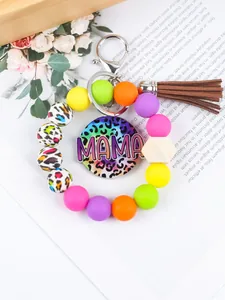 Detail of MAMA beaded keychain bracelet with colorful silicone beads and brown tassel