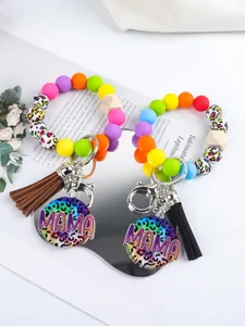 Detailed view of colorful MAMA silicone bead wristlet keychains with stylish tassels