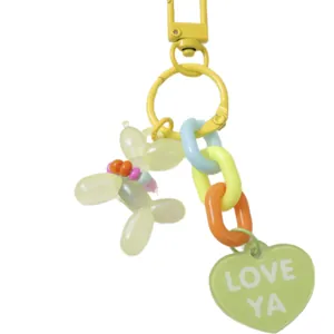 Colorful keychain featuring a balloon dog charm, rainbow chain, and heart tag with 'LOVE YA'.