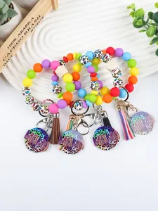 Detail view of colorful silicone bead MAMA wristlet keychains with leopard print and tassels