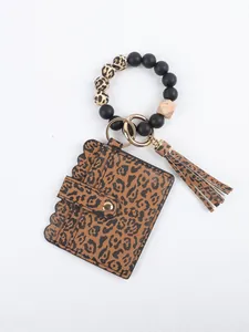 Close-up of leopard print card holder with silicone bead wristlet and tassel