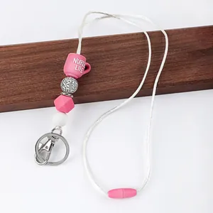 Detail of pink silicone beaded lanyard with Nurse Life cup and stethoscope pattern