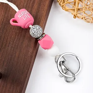 Close-up of a pink 'Nurse Life' silicone bead lanyard with a silver metal clasp
