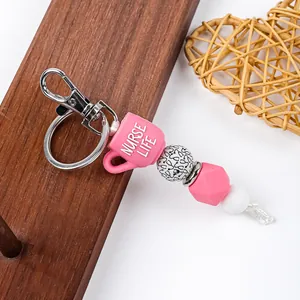 Detailed view of Nurse Life silicone bead keychain with pink cup charm and metal clasp
