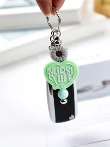 Close-up of cute green heart silicone keychain with Nurse Life text and daisy charm
