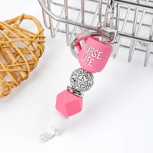 Close-up of pink Nurse Life cup and stethoscope pattern beads on a silicone keychain