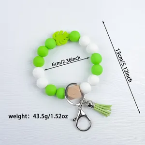 Handmade silicone beaded bracelet keychain featuring green leaf charm and tassel