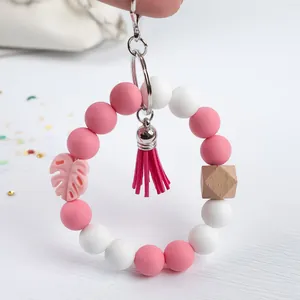 Handmade silicone beaded keychain bracelet with pink tassel and monstera leaf charm for bags