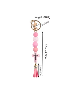 Detailed view of pink silicone beaded keychain featuring Jesus cross pendant and tassel dimensions