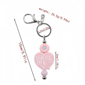 Cute pink silicone heart keychain with Nurse Life text and daisy bead charms, 15cm length
