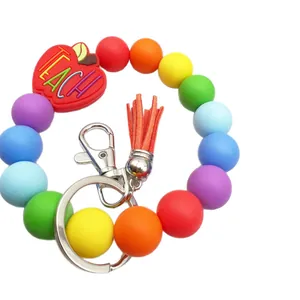 Colorful rainbow silicone beaded wristlet keychain featuring red apple charm and tassel