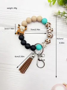 Detailed view of fashionable Highland cow silicone bead wristlet keychain with dimensions and weight