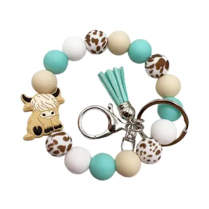 Fashionable highland cow silicone bead wristlet keychain with mint green tassel accessory