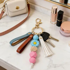 Porte-clés tendance en perles de silicone avec marguerite bleue et gland élégant