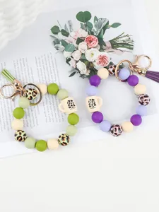 Close-up of silicone bead bracelet keychain with leopard print and mug charm