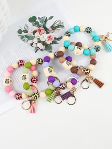 Detail of leopard print silicone bead wristlet keychains with cute cup charms