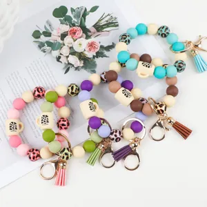 Multiple colorful silicone bead bracelet keychains with leopard print and cup charms for keys