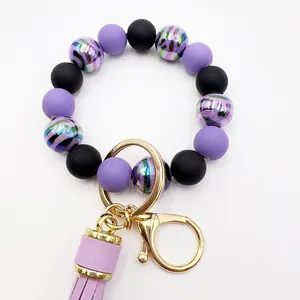 Close-up detail of UV zebra pattern beads and purple faux leather tassel keychain