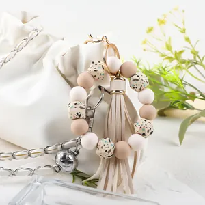 Detail of silicone beaded wristlet keychain with leather tassel and printed beads