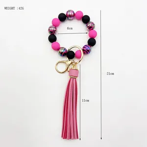 Detailed view of zebra pattern beaded wristlet keychain with pink tassel and size labels