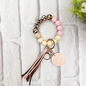 Close-up of leopard print wooden beads and pink silicone beads on a mama heart keychain