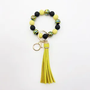 Detailed view of the UV-plated zebra stripe beaded wristlet with a yellow tassel.