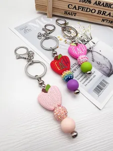 Close-up of beaded keychains with silicone apple charms and colorful beads for teachers