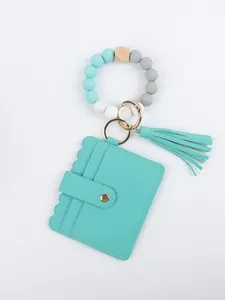 Detail of beaded wristlet keychain with turquoise PU card holder and tassel pendant