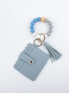Light blue PU leather card holder with beaded wristlet keychain and tassel detail