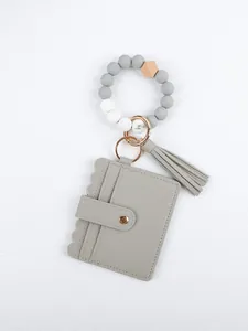 Detailed view of gray beaded wristlet keychain with PU leather card holder and matching tassel