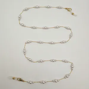 Élégante chaîne de lunettes en perles et cordon pour masque posés sur fond blanc