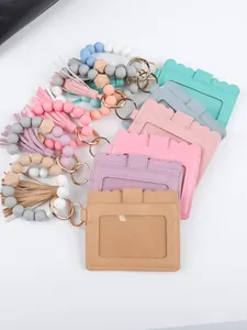 Detailed view of colorful PU leather ID card holders with bead bracelets and tassels.