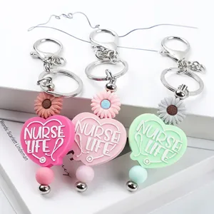 Set of three colorful silicone heart keychains featuring Nurse Life text and daisy beads