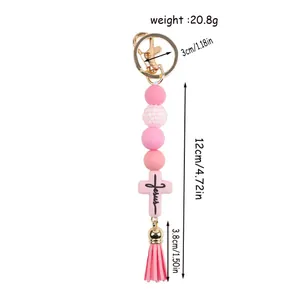 Creative pink silicone beaded keychain with Jesus cross charm and decorative tassel