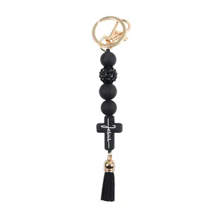 Handmade silicone beaded keychain featuring a black Jesus cross and elegant tassel charm