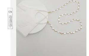 Nahaufnahme der eleganten weißen Perlen-Maskenkette und Brillenhalterkette für Damen
