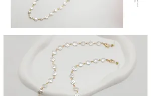 Detailansicht der eleganten Brillenkette mit weißen Coin-Perlen und Goldverschluss