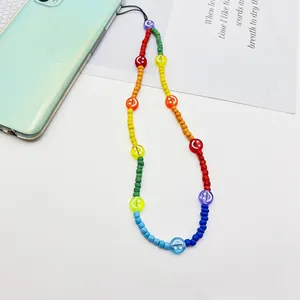 Vibrant rainbow acrylic beaded phone strap featuring cute smiley faces for smartphone