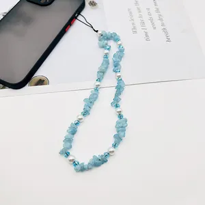Detailed close-up view of handmade blue beaded phone strap with glass and pearls