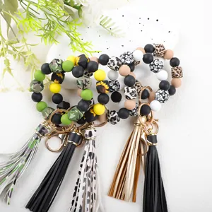 Detail view of colorful 14mm silicone bead keychain bracelets with tassels and patterns