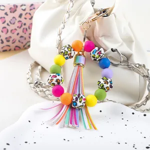 Close-up of a colorful leopard print silicone bead keychain with rainbow tassel
